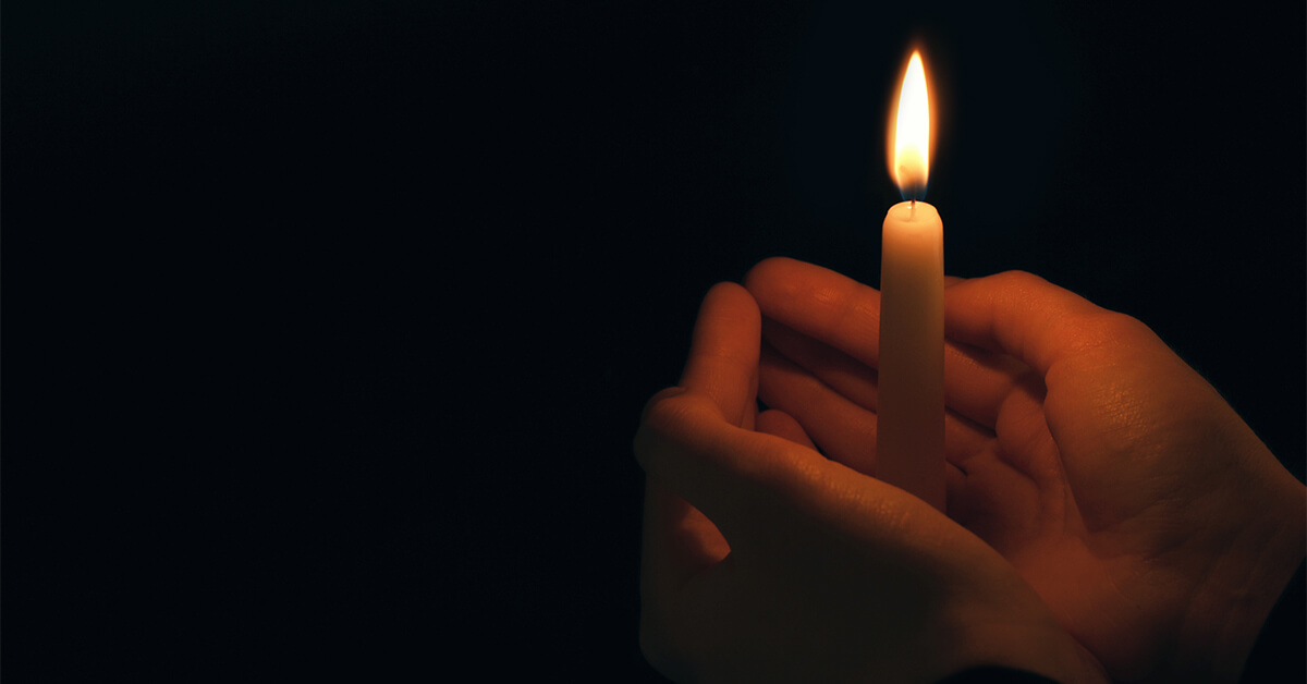 Holding a ritual candle in the darkness - Seattle Divorce Services