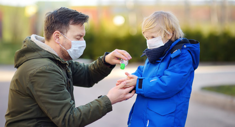 Child visitation during COVID-19 - dad and child taking precautions with masks and sanitizer - Seattle Divorce Services